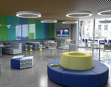 Spacious commons area with bright circular overhead lighting and cafe tables.